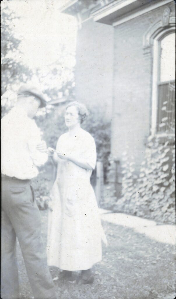 A couple by the ivied wall