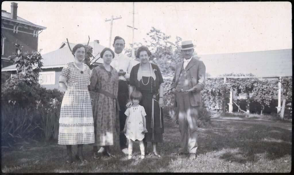 A family group before the house