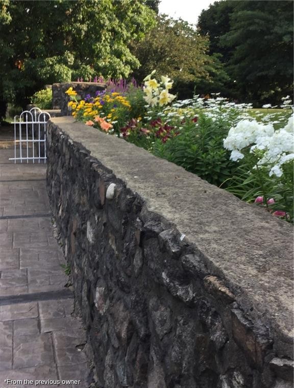 Garden bed behind the fieldstone wall